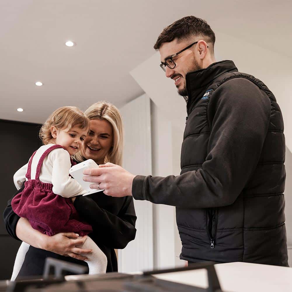 Deakins engineer demonstrating home heating thermostat