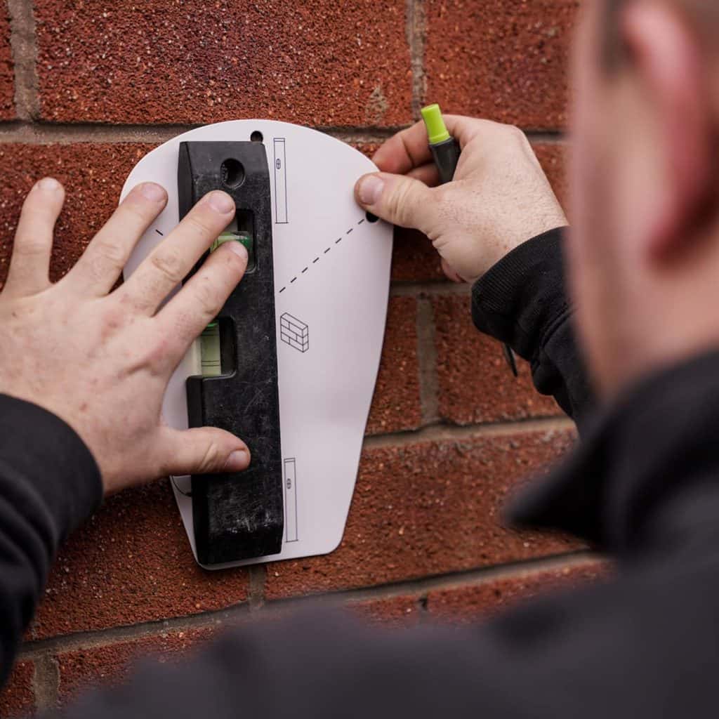 Deakins-Electrician-measuring-template-for-a-EV-Charging-Point