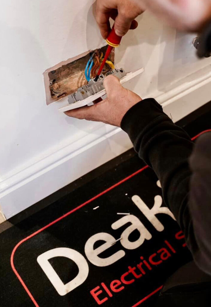 Deakin's Electrician fixing plug socket